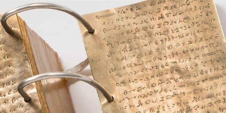 Replica of the gold plates with reformed Egyptian characters. Image via Church News.