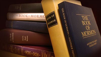 Several different editions of The Book of Mormon. Image via Scripture Central