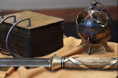 A set of model plates, sword of laban, and liahona
